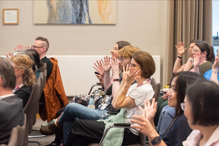 InFrame event photography in edinburgh, inside the John McIntyre Conference Centre, British Sign Language (BSL) sign for applause 